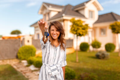 Woman holding her new house keys